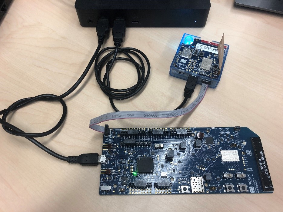 nRF9160DK & Thingy:91 connected to each other with JTAG cable and via micro-USB to the PC
